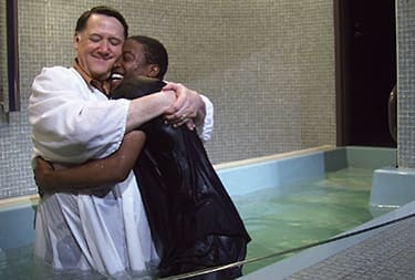 Steve Reeves embraces a new Christian after a recent baptism.